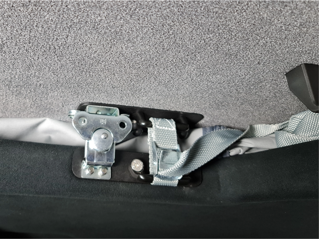 Inside of a campervan with a pop top roof with a close up to the locking mechanism which provides extra security.