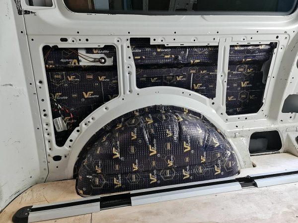 Sound deadening mats fitted to a van wheel arch and side panel
