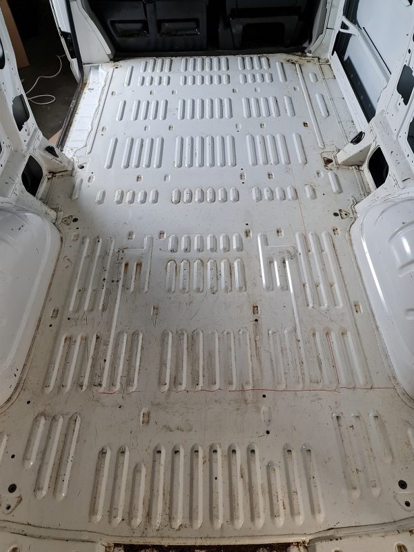 Clean corrugated metal van floor before insulation